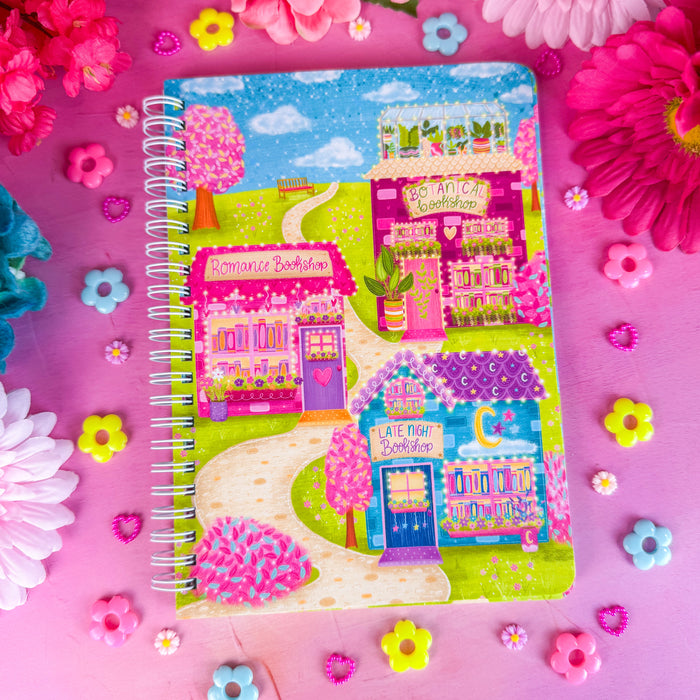 Bookshop Avenue spiral notebook on a pink backdrop