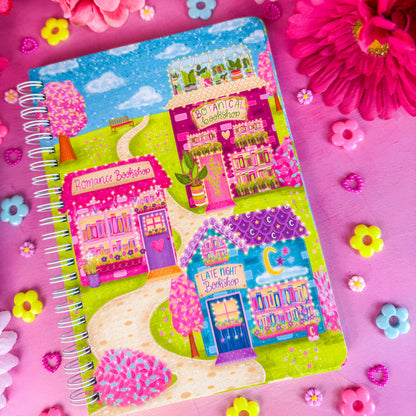 Bookshop Avenue spiral notebook on a pink backdrop