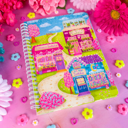 Bookshop Avenue spiral notebook on a pink backdrop