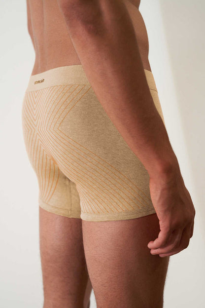 Boxer briefs in organic cotton rib, sand melange with orange cross, showcasing comfort and GOTS certified non-toxic fabric.