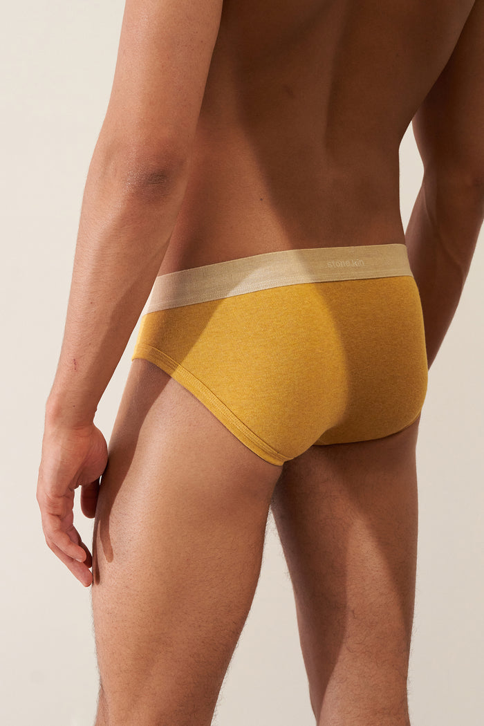 Men's Brief in Organic Cotton Rib - Mustard / Sand, back view showcasing soft stretch and comfort in organic cotton.