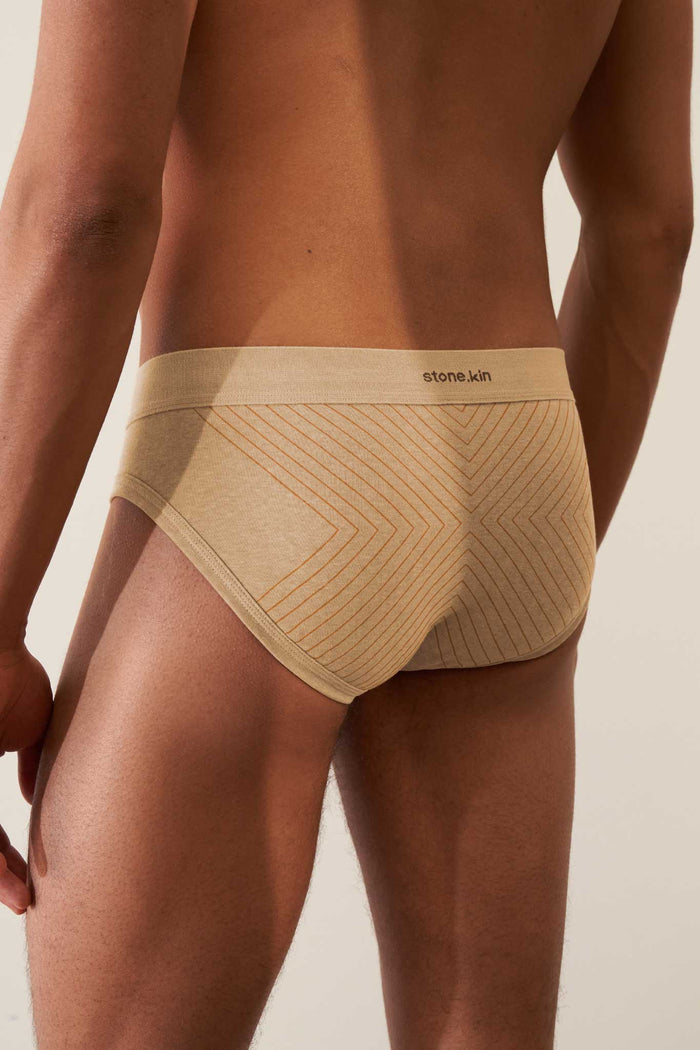 Organic cotton rib brief in sand with orange cross, featuring comfort waistband and GOTS certification.