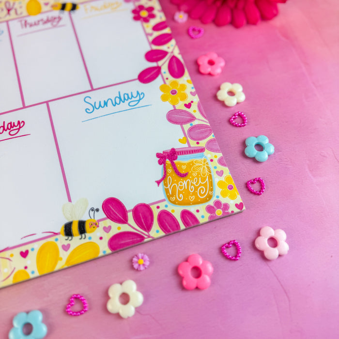 Colorful notepad with decorative elements on a pink background