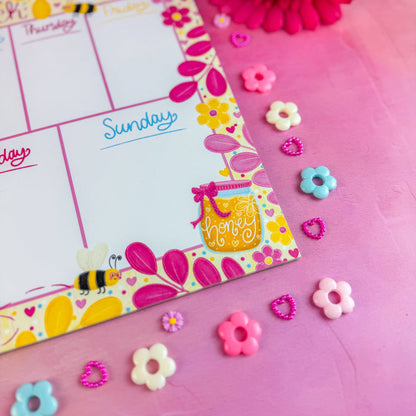 Colorful notepad with decorative elements on a pink background