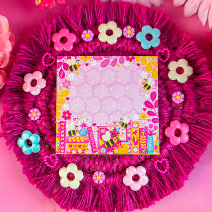 Decorative pink sticky notes with floral embellishments on a pink background