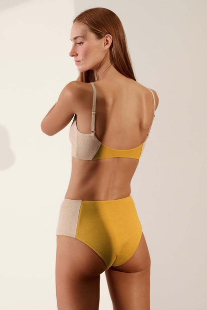 Contoured High Waisted Brief in Organic Cotton Rib in Sand & Mustard showcased on a model from the back.