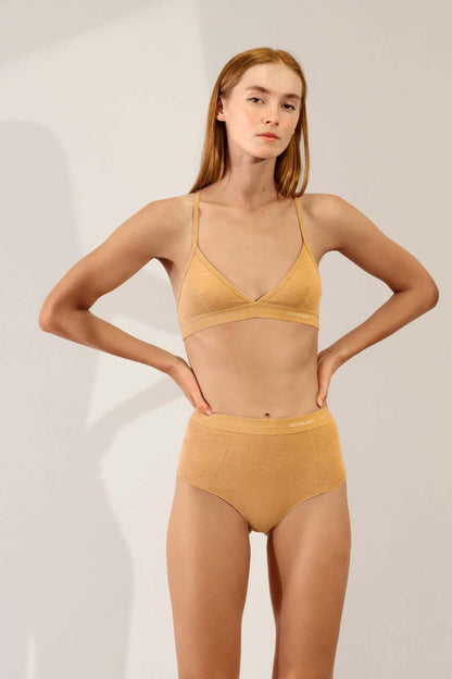 Model wearing Hi Brief in Organic Cotton Rib - Camel with matching sports bra, showcasing high-waisted design and softness.