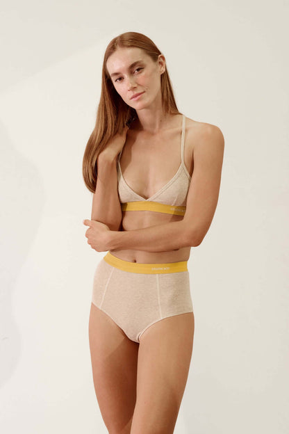 Hi Brief in Organic Cotton Rib - Sand and Mustard model showcasing high-waisted silhouette and soft organic fabric.