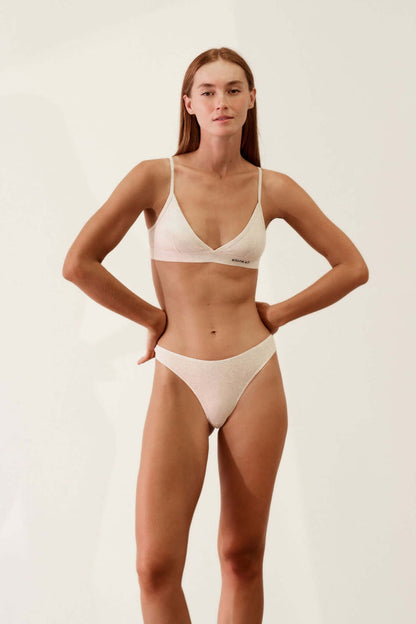 Model wearing the Hi-Thong in Organic Cotton Rib - Bone, featuring a soft and breathable design.