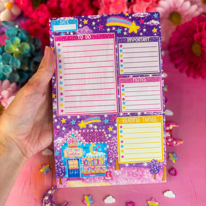 Late night bookshop daily planner notepad on pink backdrop