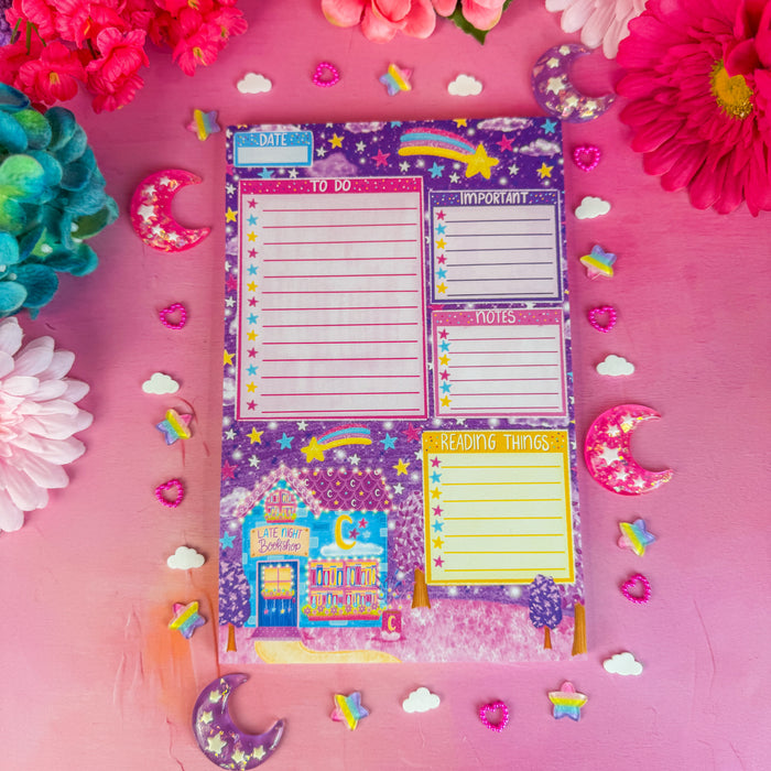 Late night bookshop daily planner notepad on pink backdrop