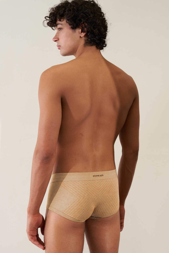 Men's organic cotton trunk in sand with orange cross, GOTS certified for comfort and non-toxic wear.