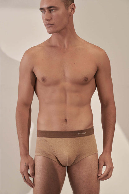 Man wearing organic cotton rib trunk in Camel with Brown Cross, showcasing comfort and GOTS certification.