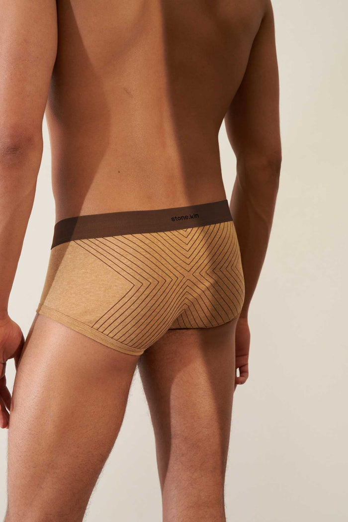 Back view of men's trunk in organic cotton rib, camel color with brown cross design, showcasing comfort and GOTS certification.