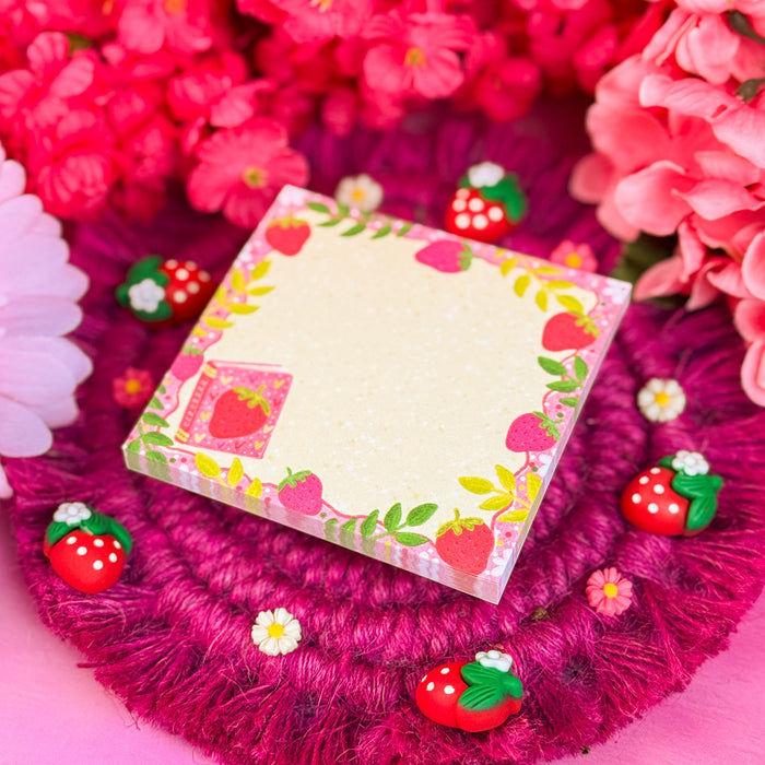Strawberry sticky notes on a pink background