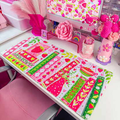 Strawberry bookshelf desk mat on a desk with pink decor