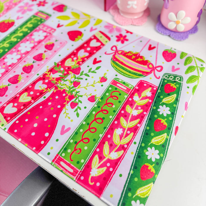 Strawberry bookshelf desk mat on a desk with pink decor