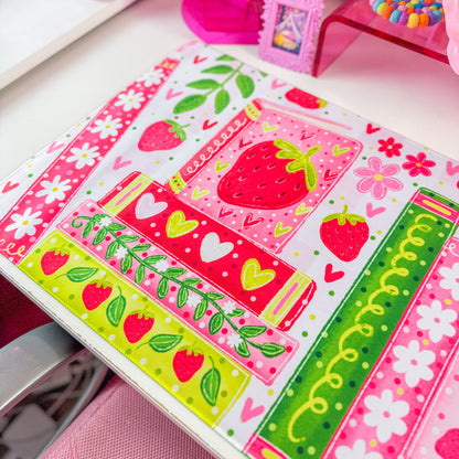 Strawberry bookshelf desk mat on a desk with pink decor