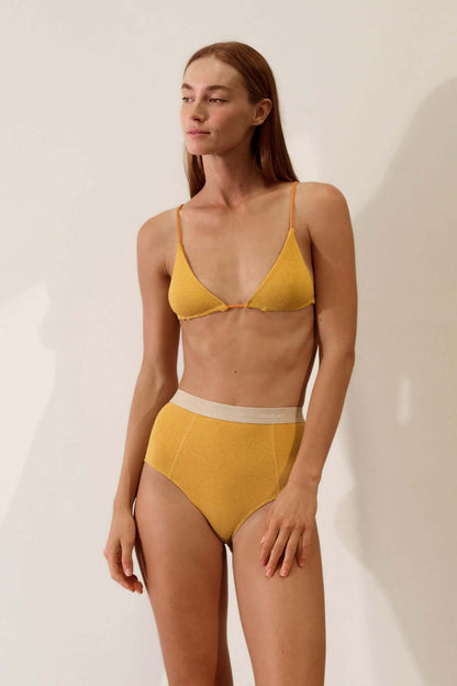 Triangle Bralette in Organic Cotton Rib - Mustard / Papaya worn by a model, showcasing the slimline design and smooth texture.