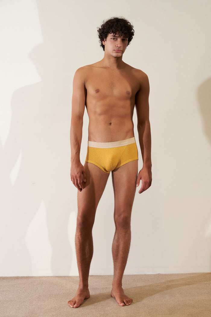 Man wearing Trunk in Organic Cotton Rib - Mustard / Sand, showcasing modern European cut and comfortable fit.