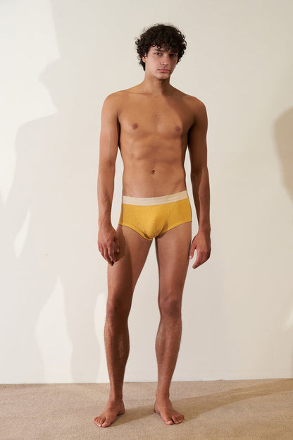 Man wearing Trunk in Organic Cotton Rib - Mustard / Sand, showcasing modern European cut and comfortable fit.